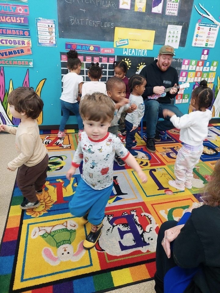 Children playing in colorful daycare classroom.