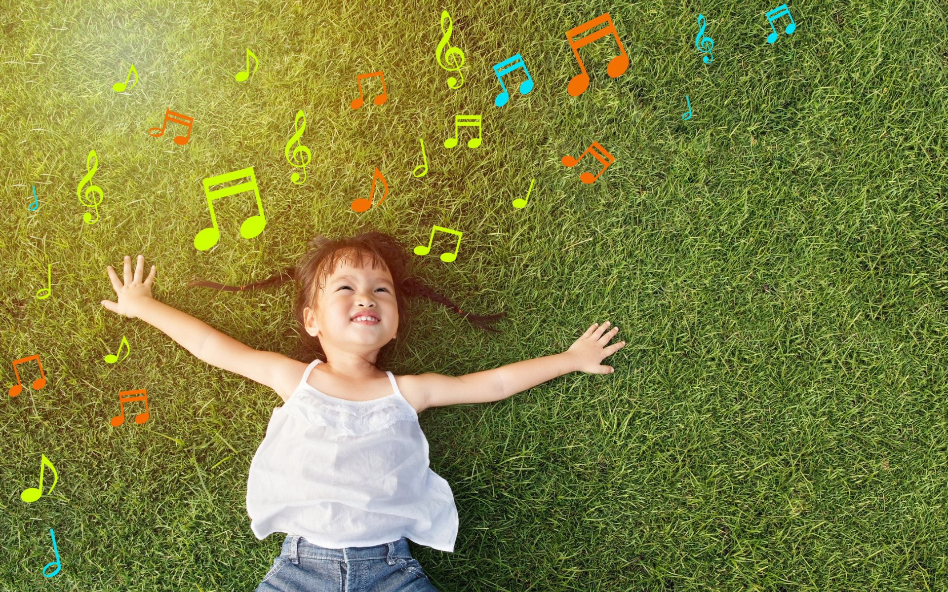 Music and Early Language Development. Child playing with musical notes outdoors