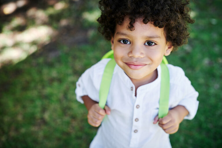 a preschooler with a green backpack showing Kindergarten Readiness